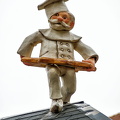 A baker decorates this Christmas market stall